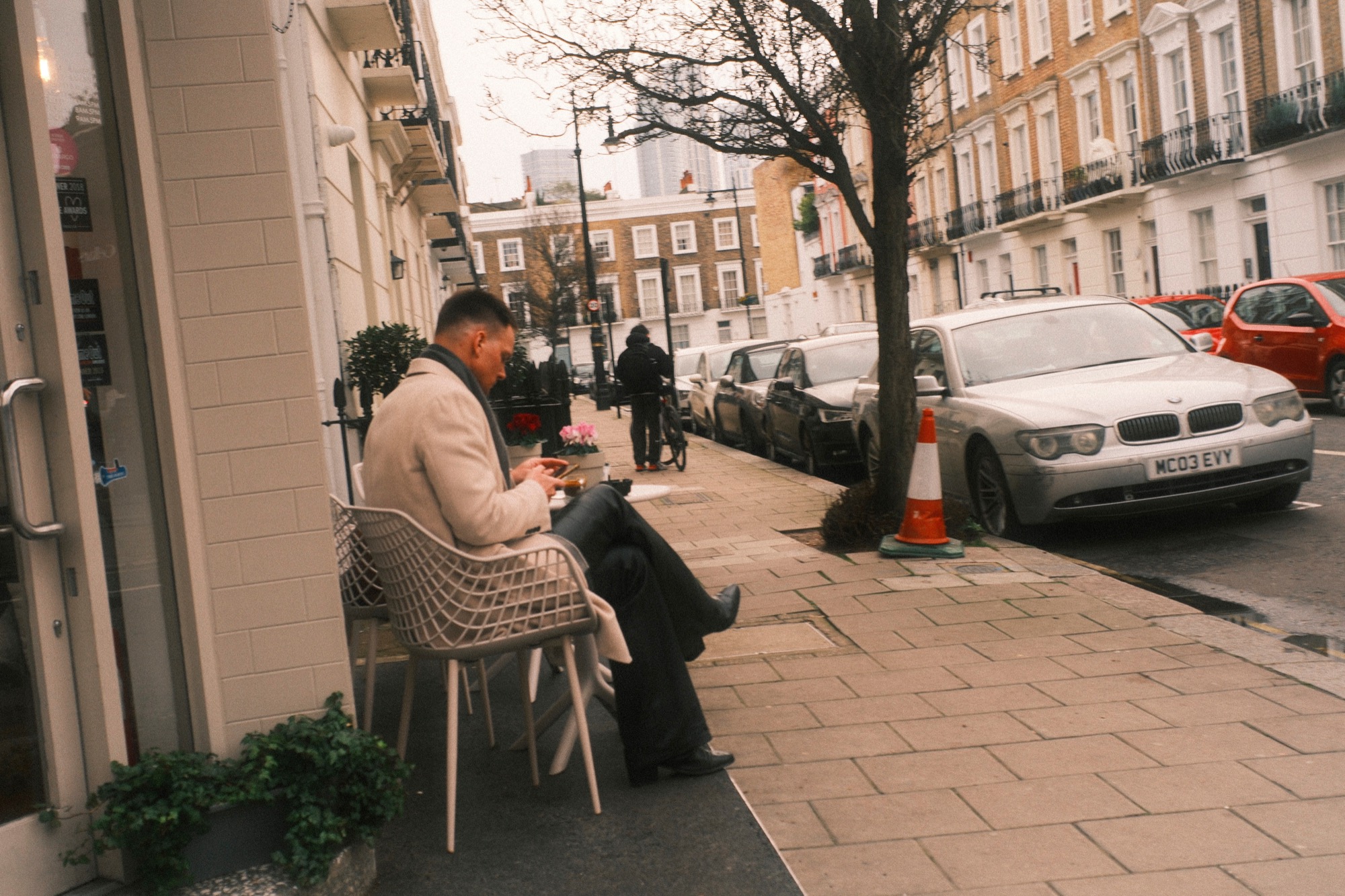 Man seated outside café, Pimlico