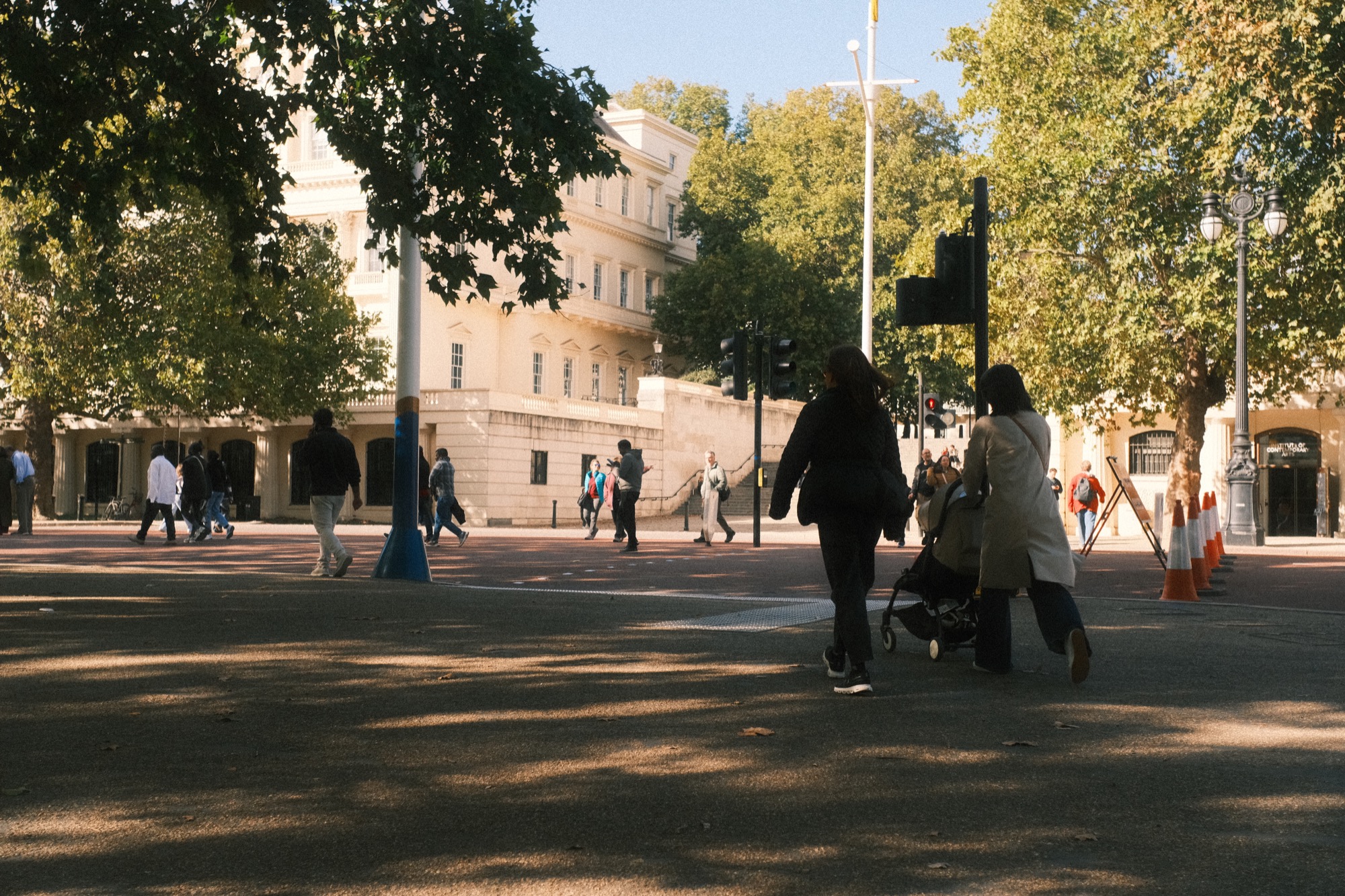 People walking along the road below the steps to Waterloo Place.
