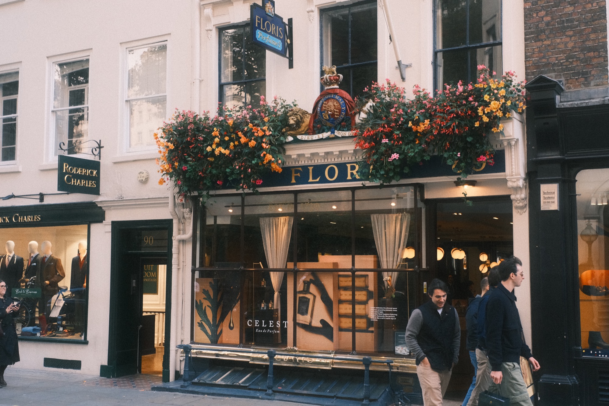 Shoppers walk past the window of the Floris shopfront.